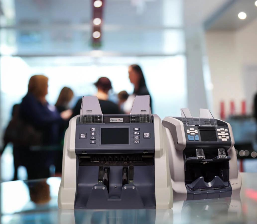 Captain Euro Jamaica Money Counters Benefits Image with money counter and people blurred in the background